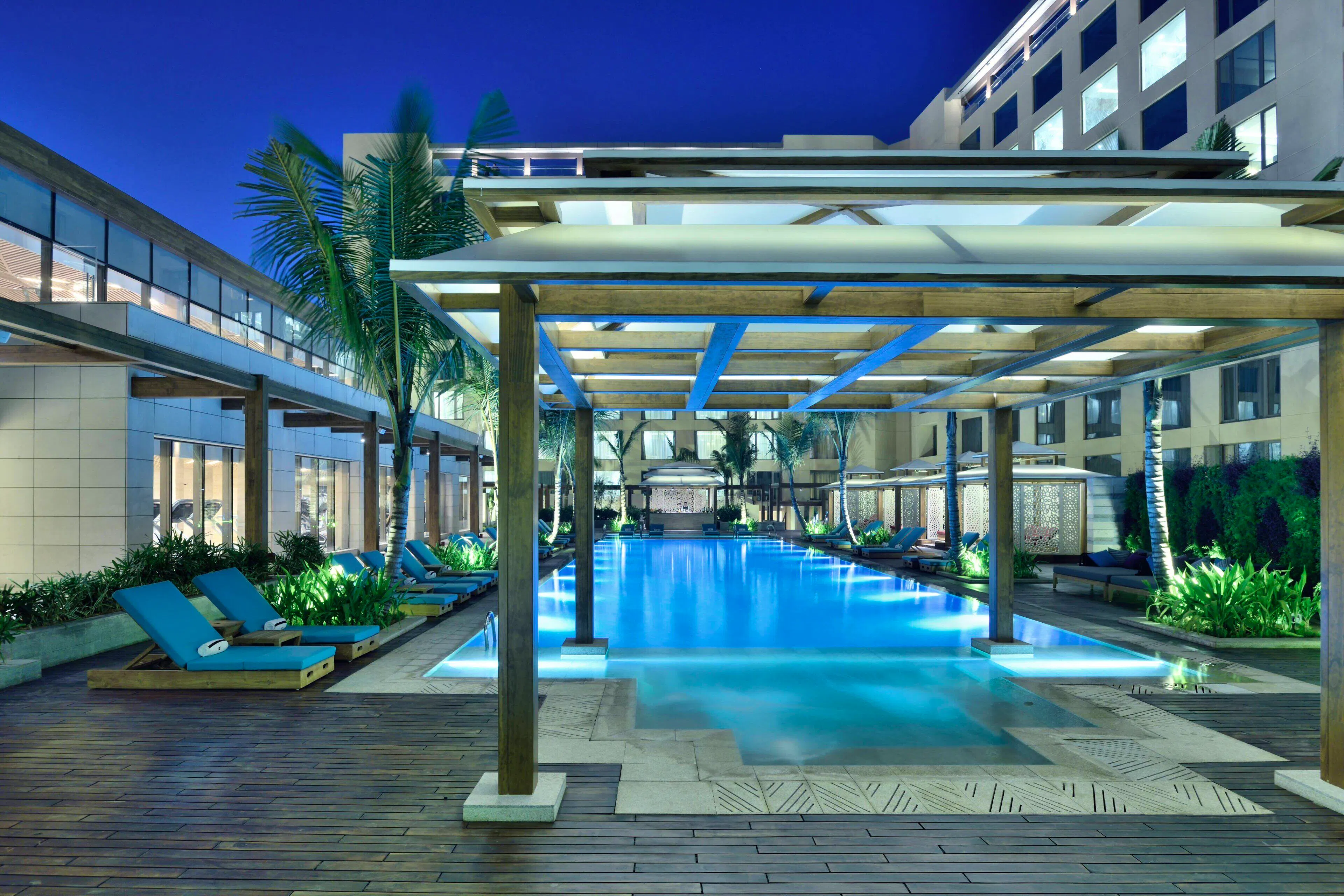 Outdoor pool with lounge chairs at JW Marriott Mumbai Sahar