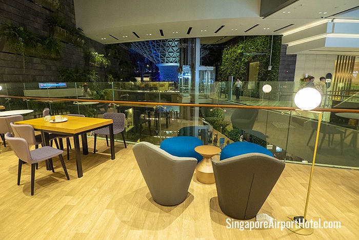 KOMYUNITI dining lounge overlooks the famous Rain Vortex at Jewel Changi Airport