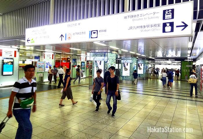 Overhead signs point the way for passengers at Hakata Station