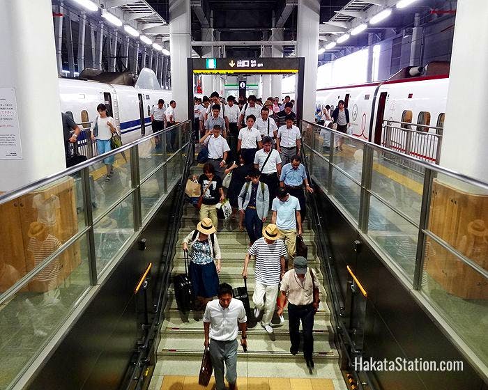 Passengers descend from bullet train platforms at Hakata Station