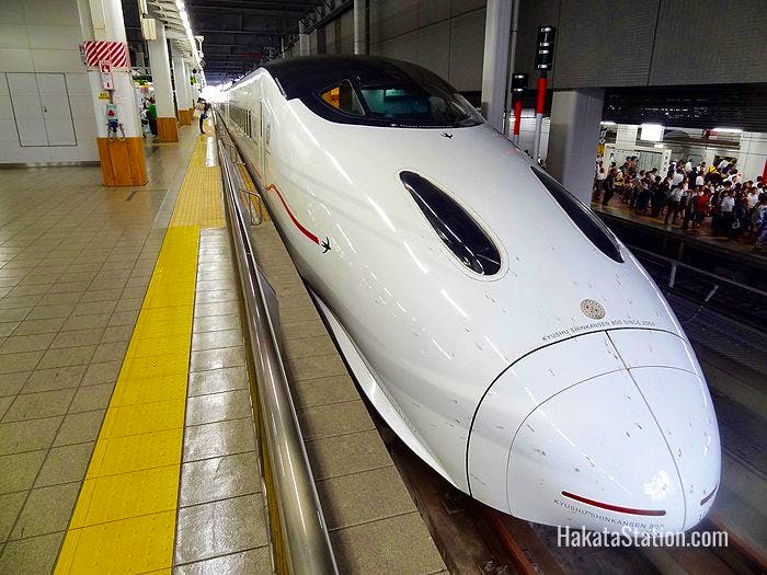 An 800 Series Kyushu Shinkansen boards passengers at Hakata Station in Fukuoka