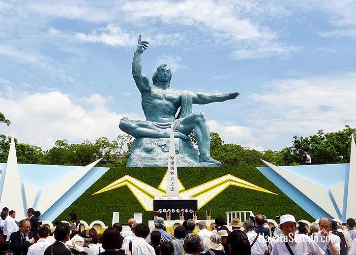 The 10-meter-tall Peace Statue by Seibo Kitamura dominates Nagasaki’s Peace Park, seen here during a memorial ceremony
