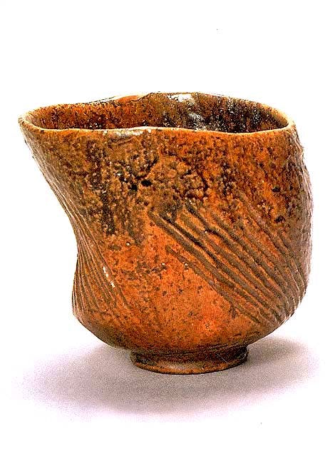 This famous tea bowl by the 1st Ohi Chozaemon is called Hijiri” or Saint.” The rich amber color is typical of Ohi pottery