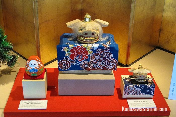 A traditional self-righting doll and shishi lion heads