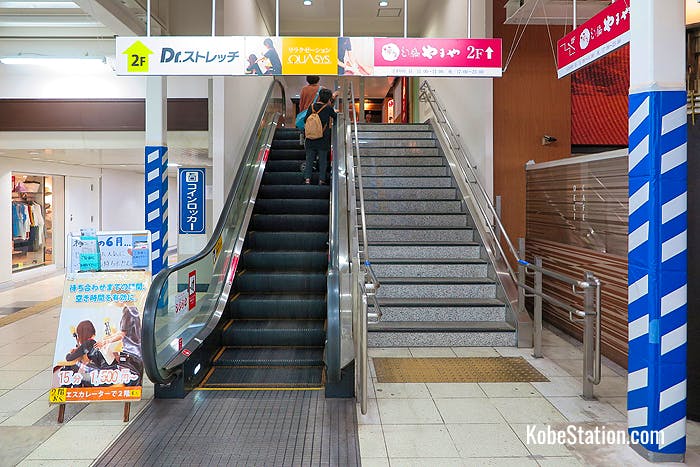 Stairs and an escalator leading to the West Ticket Gate
