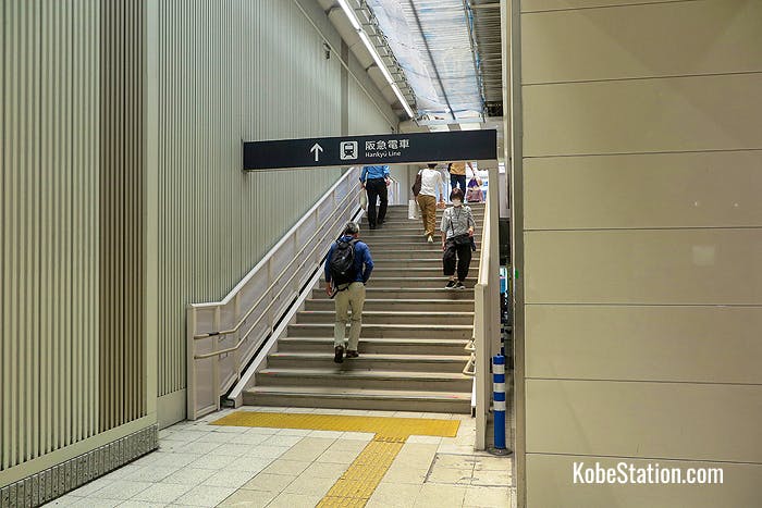 Stairs leading to the overhead walkway for the Hankyu station