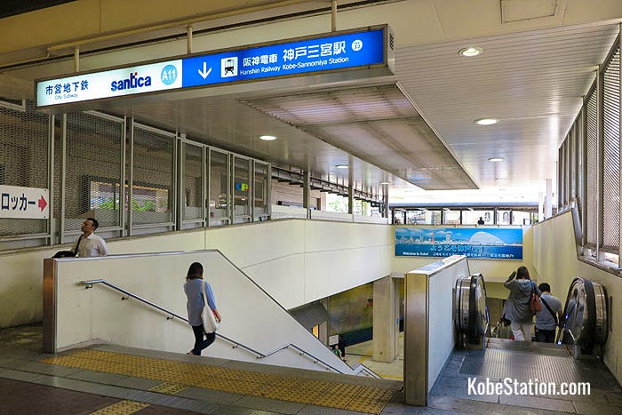 Stairs and an escalator leading down to Hanshin Kobe-Sannomiya Station