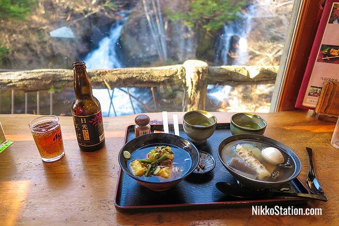 Local Iroha craft beer with a bowl of ozoni on the left and oden on the right (both served with tea)