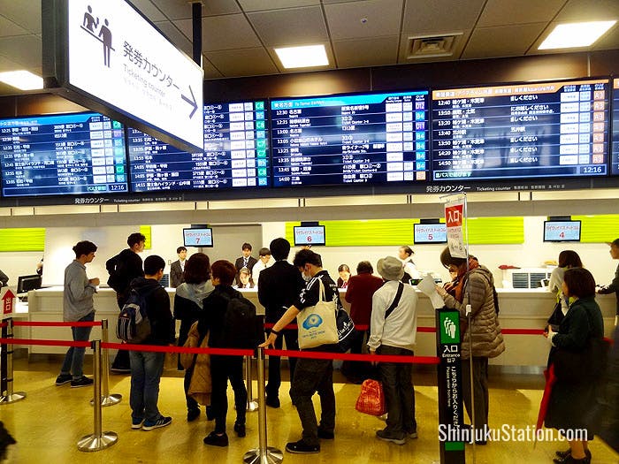 Passengers queue for tickets on the fourth floor of Basuta Shinjuku