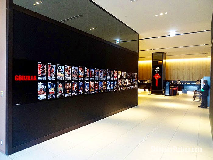 Godzilla movie posters along the hallway leading to the lobby