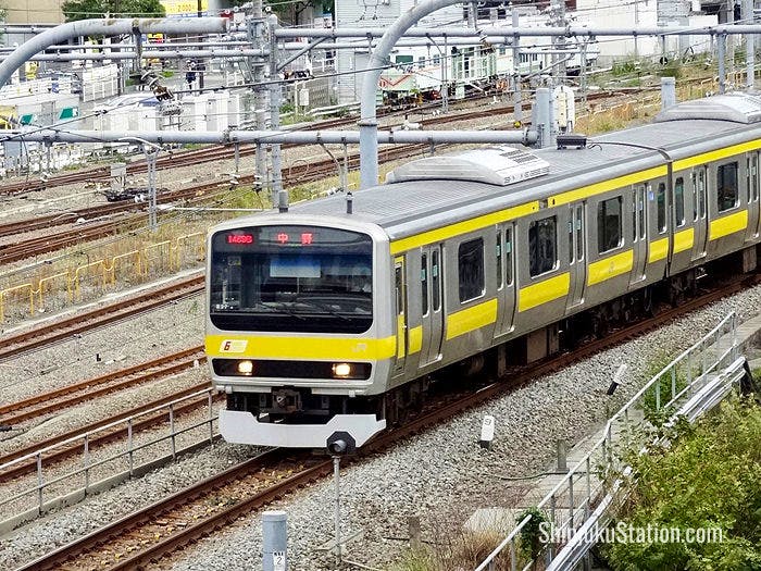 A JR Chuo-Sobu Line train bound for Nakano approaches Shinjuku Station