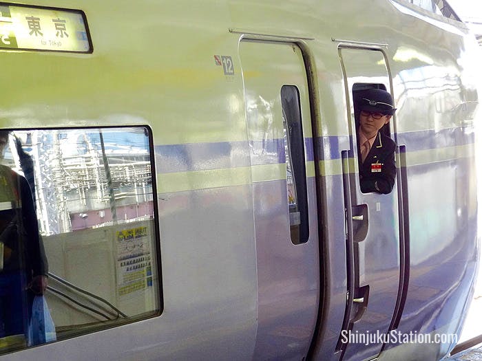 An Azusa limited express train stops at Shinjuku