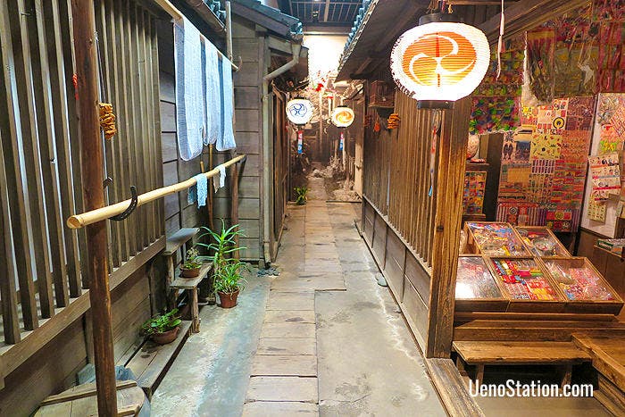 A recreated tenement alleyway with a dagashiya sweet shop on the right